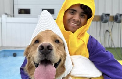 golden retriever and gentleman smiling at camera in banana suits